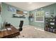 Light-filled bedroom with natural light, a wooden desk, and simple decor on display at 24702 E Ontario Dr, Aurora, CO 80016