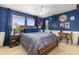 Bedroom with blue walls, carpet floors, a bed, and lots of decor on display at 24702 E Ontario Dr, Aurora, CO 80016