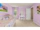 Bright bedroom featuring pink walls, artwork, and a desk at 24702 E Ontario Dr, Aurora, CO 80016
