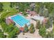 Aerial view of the community pool showcasing its size and layout with lounge chairs and mature landscaping at 24702 E Ontario Dr, Aurora, CO 80016