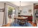 Cozy dining area with wood floors, a circular table, and sliding glass doors to the backyard at 24702 E Ontario Dr, Aurora, CO 80016