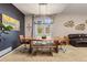 Bright dining room with a unique wooden table, modern chandelier, and stylish decor at 24702 E Ontario Dr, Aurora, CO 80016