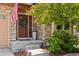 Inviting front entrance featuring a decorative wreath, stone accents, and manicured landscaping at 24702 E Ontario Dr, Aurora, CO 80016