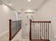 The hallway has white walls, dark wood railing, carpet on the stairs, and nice wall decor at 24702 E Ontario Dr, Aurora, CO 80016