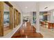 Elegant hallway featuring wood floors, decorative columns, and stylish wall decor at 24702 E Ontario Dr, Aurora, CO 80016