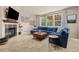 Comfortable living room with a fireplace, large windows, and a spacious sectional sofa at 24702 E Ontario Dr, Aurora, CO 80016