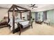 Spacious main bedroom features a four-poster bed, sitting area, and lots of natural light at 24702 E Ontario Dr, Aurora, CO 80016