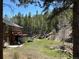 Spacious backyard featuring a patio, picnic area, solar panels, and a charming mountain home exterior at 72 Rudi W Ln, Golden, CO 80403