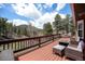 Scenic deck with a fire pit, seating, and views of the surrounding mountains and trees at 72 Rudi W Ln, Golden, CO 80403