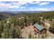 Secluded mountain home with green roof, solar panels, and a large deck overlooking the mountains at 72 Rudi W Ln, Golden, CO 80403