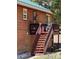 Stairs lead to a cozy deck with wood railings on a charming mountain home exterior at 72 Rudi W Ln, Golden, CO 80403