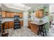 Bright kitchen with wooden cabinets, granite countertops, wood-look tile flooring, and modern appliances at 72 Rudi W Ln, Golden, CO 80403