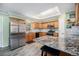 Modern kitchen featuring stainless steel appliances, a spacious granite island, and stylish backsplash at 72 Rudi W Ln, Golden, CO 80403