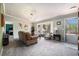 Bright living room featuring a large bay window, carpet flooring, and a comfortable seating area at 72 Rudi W Ln, Golden, CO 80403