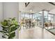 Modern dining area with city views through floor-to-ceiling windows and stylish furnishings at 1700 Bassett St # 1111, Denver, CO 80202