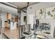 View of a dining area and kitchen, featuring concrete ceilings and modern lighting at 1700 Bassett St # 1111, Denver, CO 80202