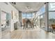 Modern dining area with city views through floor-to-ceiling windows and stylish furnishings at 1700 Bassett St # 1111, Denver, CO 80202
