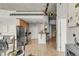 Open-concept kitchen with stainless steel appliances, a breakfast bar, and hardwood flooring at 1700 Bassett St # 1111, Denver, CO 80202