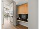 Modern condo featuring a kitchen area with black tile backsplash and sleek light wood cabinets at 1700 Bassett St # 1111, Denver, CO 80202