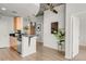 Open concept kitchen with wood cabinets, modern pendant lights, and concrete ceiling at 1700 Bassett St # 1111, Denver, CO 80202