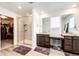 Bright bathroom with double vanity, granite counters, and a glass enclosed shower at 960 S De Gaulle Ct, Aurora, CO 80018
