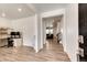 Welcoming foyer with wood-look floors, modern lighting, and views into the adjacent office and living spaces at 960 S De Gaulle Ct, Aurora, CO 80018