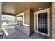 Inviting front porch with stone accents, a decorative front door, and ample space for relaxing outdoors at 960 S De Gaulle Ct, Aurora, CO 80018