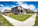 Beautifully landscaped front yard of a two-story home featuring a green lawn, a sidewalk, and a wooden fence at 960 S De Gaulle Ct, Aurora, CO 80018