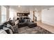 Spacious living area featuring a large sectional sofa, wood floors, and an open layout to the modern kitchen at 960 S De Gaulle Ct, Aurora, CO 80018