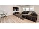 Comfortable living room with a sectional sofa, modern fireplace, and large windows for natural light and backyard views at 960 S De Gaulle Ct, Aurora, CO 80018