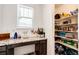 Pantry and counter with granite surfaces, plenty of shelving for storage, and a bright, windowed workspace at 960 S De Gaulle Ct, Aurora, CO 80018