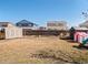 Spacious backyard featuring a grass area, wooden fence, and shed for storage at 896 Willow Dr, Brighton, CO 80603