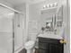 Bathroom featuring glass shower, toilet and vanity with black cabinets at 896 Willow Dr, Brighton, CO 80603