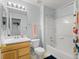 Bright bathroom featuring a vanity, toilet, and bathtub with shower with stylish light blue walls at 896 Willow Dr, Brighton, CO 80603