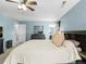 The bedroom boasts natural light, neutral tones and an en-suite bathroom at 896 Willow Dr, Brighton, CO 80603