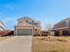Charming two-story home with neutral siding, attached garage, and a well-maintained front yard at 896 Willow Dr, Brighton, CO 80603