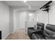 Cozy entertainment room with plush leather chairs and wall-mounted projector at 896 Willow Dr, Brighton, CO 80603