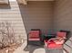 Cozy outdoor seating area with two chairs and a small table on a covered porch at 896 Willow Dr, Brighton, CO 80603