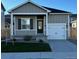 Charming single-story home featuring a well-manicured lawn and an attached two-car garage, enhancing curb appeal at 857 Sawdust Dr, Brighton, CO 80601
