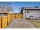 Gravel driveway and wooden fence access to backyard at 1061 Elbert St, Denver, CO 80221