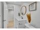 Basement bathroom with vanity, toilet and a view of another room at 1061 Elbert St, Denver, CO 80221