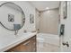 Clean and updated bathroom with a large vanity and neutral color palette at 1061 Elbert St, Denver, CO 80221