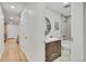 Modern bathroom with a soaking tub, updated vanity, and neutral tile at 1061 Elbert St, Denver, CO 80221