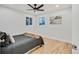 Bright bedroom featuring hardwood floors and a ceiling fan at 1061 Elbert St, Denver, CO 80221