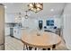 Bright dining area with a round wooden table and modern light fixture at 1061 Elbert St, Denver, CO 80221