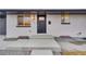 Modern front entry with gray door and updated light fixture at 1061 Elbert St, Denver, CO 80221