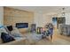 Living room features a modern fireplace and wood-paneled feature wall at 1061 Elbert St, Denver, CO 80221