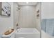 Updated bathroom shower with neutral tile and modern fixtures at 1061 Elbert St, Denver, CO 80221