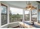 Bright breakfast nook features beautiful views and a custom pendant light fixture at 7815 Armadillo Trl, Evergreen, CO 80439
