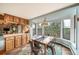 Cozy dining area with a view features a bay window and built-in cabinets adjacent to the kitchen at 7815 Armadillo Trl, Evergreen, CO 80439